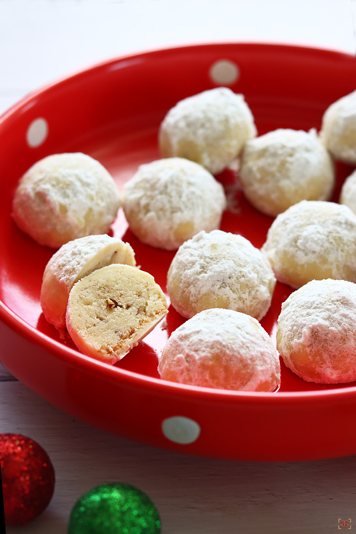 snowball cookies placed in a red plate